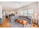Bright living room featuring a sectional sofa, hardwood floors, area rug, and kitchen view at 126 W 2Nd St, Folly Beach, SC 29439