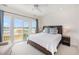 Bright main bedroom with access to a balcony and scenic water views, promoting relaxation and tranquility at 126 W 2Nd St, Folly Beach, SC 29439