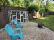 Serene backyard with stone patio, fire pit, chairs and unique cat enclosure for outdoor enjoyment at 133 Wando Reach Rd, Wando, SC 29492