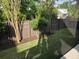 A well-maintained backyard featuring a lush green lawn, privacy fence and young trees for added greenery at 133 Wando Reach Rd, Wando, SC 29492