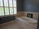 Stylish soaking tub bathed in natural light, perfect for unwinding in a serene bathroom setting at 133 Wando Reach Rd, Wando, SC 29492
