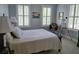 Bedroom with a queen-sized bed dressed with a white quilt and two windows providing natural light at 133 Wando Reach Rd, Wando, SC 29492