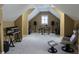 Spacious bonus room with neutral colored walls and carpet, large windows and assorted musical instruments at 133 Wando Reach Rd, Wando, SC 29492