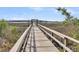 Scenic dock featuring a wooden walkway with marshland views at 133 Wando Reach Rd, Wando, SC 29492