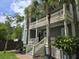 Inviting home showcasing dual porches, stately columns, and lush landscaping at 133 Wando Reach Rd, Wando, SC 29492