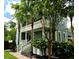 Charming home featuring double porches, palm trees, and beautiful landscaping at 133 Wando Reach Rd, Wando, SC 29492