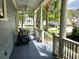 Relaxing covered porch featuring comfortable seating and scenic neighborhood views at 133 Wando Reach Rd, Wando, SC 29492