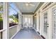 Charming screened-in porch offers an ideal spot for relaxation with comfortable seating at 133 Wando Reach Rd, Wando, SC 29492