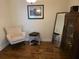 Inviting sitting room with a cozy chair, stylish decor, and rich hardwood floors at 133 Wando Reach Rd, Wando, SC 29492