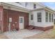 Red brick and white siding highlight this backyard space, complete with steps, gravel and flowers at 1534 Salisbury St, Charleston, SC 29407