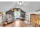Cozy Bedroom with hardwood floors, floral wallpaper, crib, glider chair, and play area at 1534 Salisbury St, Charleston, SC 29407
