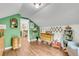Bright bedroom featuring green walls, hardwood floors, and a fun assortment of toys and furniture at 1534 Salisbury St, Charleston, SC 29407