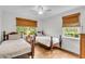 Bright bedroom featuring wood floors, white walls, and two twin beds with wood frames at 1534 Salisbury St, Charleston, SC 29407