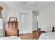 Bedroom showcasing wood floors, white walls, a wood dresser, and access to other rooms at 1534 Salisbury St, Charleston, SC 29407