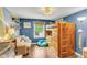 Bright bedroom featuring blue walls, hardwood floors, a wooden bunk bed, and a sitting area at 1534 Salisbury St, Charleston, SC 29407