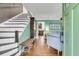 Inviting entryway with hardwood floors, staircase, and an open view to the living room at 1534 Salisbury St, Charleston, SC 29407