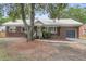 Classic brick home with metal roof, green door, and mature trees at 1534 Salisbury St, Charleston, SC 29407
