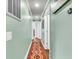 Hallway with light-green painted walls, wood floors, and a decorative rug at 1534 Salisbury St, Charleston, SC 29407