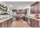 Well-equipped kitchen featuring stainless steel appliances, granite countertops, and dark wood cabinetry at 1534 Salisbury St, Charleston, SC 29407