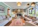 Bright living room with hardwood floors, brick fireplace, and comfortable seating at 1534 Salisbury St, Charleston, SC 29407