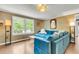 Bright living room featuring a blue sectional sofa, wood floors, and a large window at 1534 Salisbury St, Charleston, SC 29407
