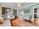 Comfortable living room with hardwood floors, a modern light fixture, and an open floor plan at 1534 Salisbury St, Charleston, SC 29407