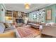 Inviting living room with a brick fireplace, built-in shelves, and large windows at 1534 Salisbury St, Charleston, SC 29407