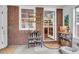 Mudroom with brick wall, shoe rack, and access to the kitchen featuring modern cabinetry at 1534 Salisbury St, Charleston, SC 29407