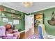 Office with green walls, hardwood floors, and floating shelves for added storage and display at 1534 Salisbury St, Charleston, SC 29407