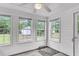 Bright sunroom with white walls, multiple windows offering views, and concrete flooring at 1534 Salisbury St, Charleston, SC 29407