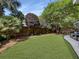 Lush green backyard featuring a well-maintained lawn, trees, and plants along the fence at 16 Charlyn Dr, Charleston, SC 29407
