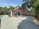 A spacious backyard featuring a brick patio, tall palm trees, and a fence at 16 Charlyn Dr, Charleston, SC 29407