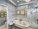 Bright bathroom featuring clawfoot tub, marble floors, and a tiled glass shower at 16 Charlyn Dr, Charleston, SC 29407