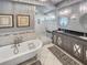Stylish bathroom with a clawfoot tub, tiled shower, and a gray double vanity at 16 Charlyn Dr, Charleston, SC 29407