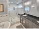 Modern bathroom featuring a large glass shower and double vanity with granite countertops at 16 Charlyn Dr, Charleston, SC 29407