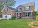 Charming brick home featuring a cozy front porch, well-manicured lawn, and inviting curb appeal at 16 Charlyn Dr, Charleston, SC 29407