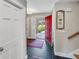 Welcoming foyer with slate floors, a red front door, and white trim at 16 Charlyn Dr, Charleston, SC 29407