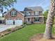 Charming two-story brick home with a well-manicured lawn, two-car garage, and inviting front porch at 16 Charlyn Dr, Charleston, SC 29407