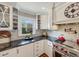 Bright kitchen featuring stainless steel range, custom cabinetry, and black countertops at 16 Charlyn Dr, Charleston, SC 29407
