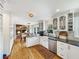 Open-concept kitchen with white cabinetry, stainless steel appliances, and dining area at 16 Charlyn Dr, Charleston, SC 29407