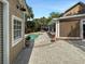 View of the backyard pool, a sunroom with shade and lush landscaping at 16 Charlyn Dr, Charleston, SC 29407