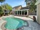 Private backyard pool with a paver patio, dining table and chairs, and a sunroom at 16 Charlyn Dr, Charleston, SC 29407