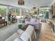 Beautifully decorated sunroom with cozy seating, hardwood floors, and access to the backyard at 16 Charlyn Dr, Charleston, SC 29407