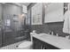 Modern bathroom featuring gray tiled shower, dark vanity, and patterned floor tiles at 177 Spring St, Charleston, SC 29403
