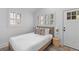 Light and airy bedroom featuring a bed with white linens, shuttered windows, and stylish lighting at 177 Spring St, Charleston, SC 29403