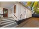 Charming cottage-style home featuring white siding, wooden shutters, and a quaint front porch with inviting steps at 177 Spring St, Charleston, SC 29403