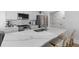 Bright kitchen showcasing an expansive island with marble countertop and stainless steel appliances at 177 Spring St, Charleston, SC 29403