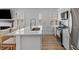 Modern kitchen showcasing a large island with a sink, stainless steel appliances, and bright natural light at 177 Spring St, Charleston, SC 29403