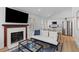 Open-concept living space featuring a fireplace, large television, and an adjacent modern kitchen at 177 Spring St, Charleston, SC 29403