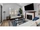 Bright living room featuring a fireplace, plantation shutters, and comfortable seating with stylish decor at 177 Spring St, Charleston, SC 29403
